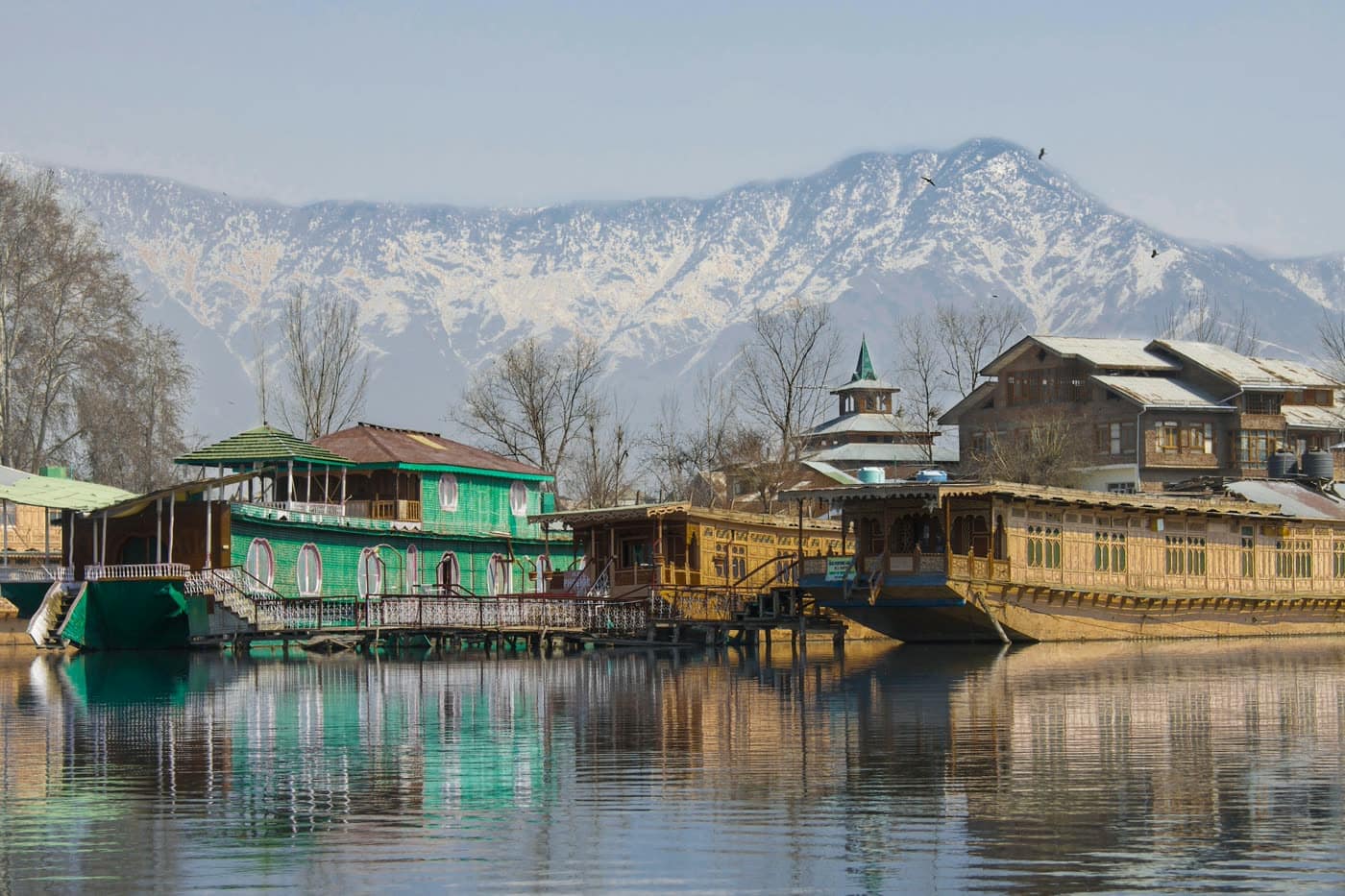 Houseboats on Dal Lake below snow-covered mountains, Srinagar
